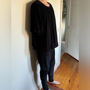 Looks and feels  like velvet. Very comfortable outfit. Size 2X